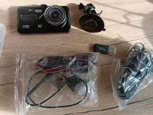 Car dashboard camera with accessories on a wooden surface