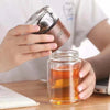 Removing the wood-finish infuser top from a SipEase tea bottle