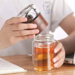 Removing the wood-finish infuser top from a SipEase tea bottle
