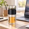 Black SipEase 200ml tea infuser bottle beside a laptop on a desk