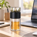Black SipEase 200ml tea infuser bottle beside a laptop on a desk