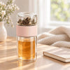 Pink SipEase 200ml glass tea infuser bottle filled with loose-leaf tea