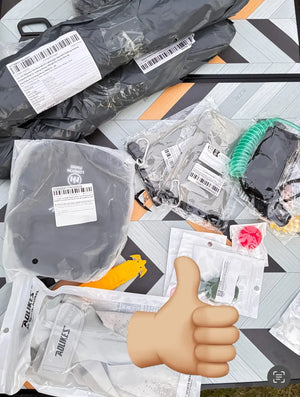 Unopened electronic components in clear packaging with a thumbs-up emoji on a patterned surface.