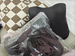 Black car seat cover on a chair with clear plastic wrap