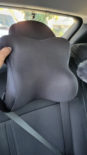 Gray car headrest cover being adjusted in a vehicle