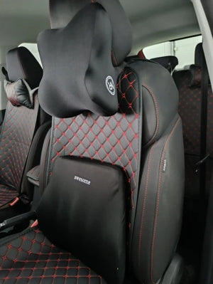 Car seat with black and red quilted design, featuring a brand logo.