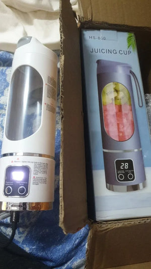 Electric juicer with digital display on a cardboard box background