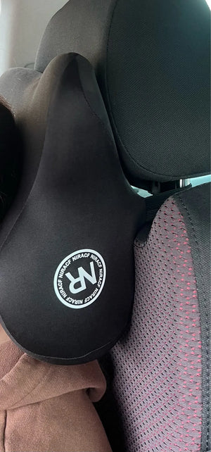 Close-up of a black seat cover with a logo on a vehicle seat