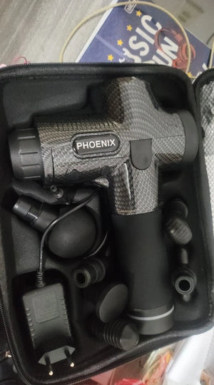 Phoenix massage gun in a black case with a blurred background