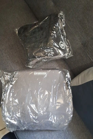 Two plastic-wrapped items on a textured surface