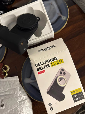 Box of a cellphone selfie light on a wooden surface