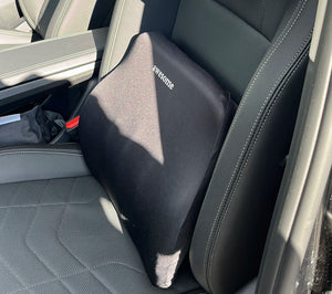 Black pillow with 'Awesome' text on a car seat