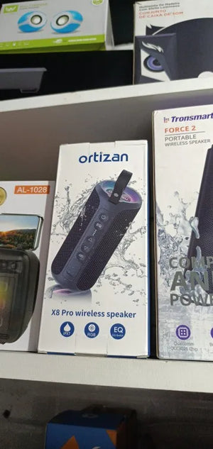Two wireless speaker boxes, one labeled 'ortisan' and the other 'Transmart', on a shelf.