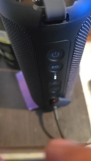 Close-up of a handheld electronic device with control buttons on a blurred background