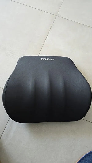 Black cushion with 'awesome' text on a tiled floor