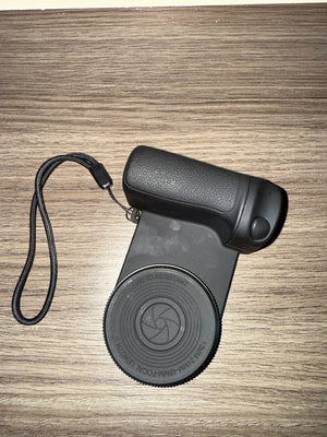 Black monocular on a wooden surface