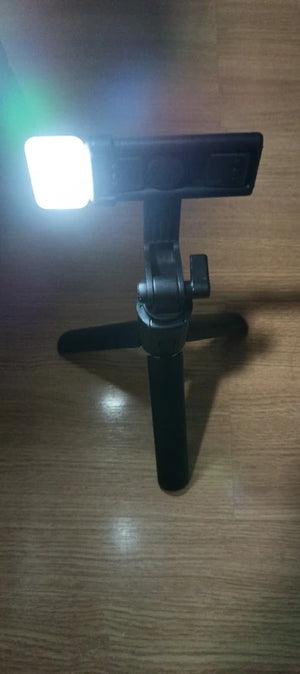 Small light on a stand on a wooden surface