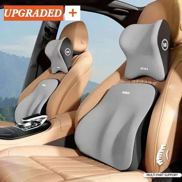 Gray car headrest and lumbar support pillows on a beige car interior with scenic background.
