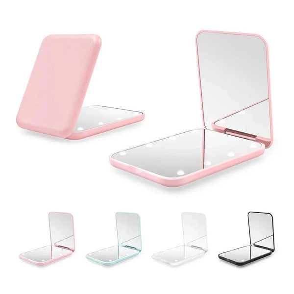 Set of compact mirrors with pink frames on a white background
